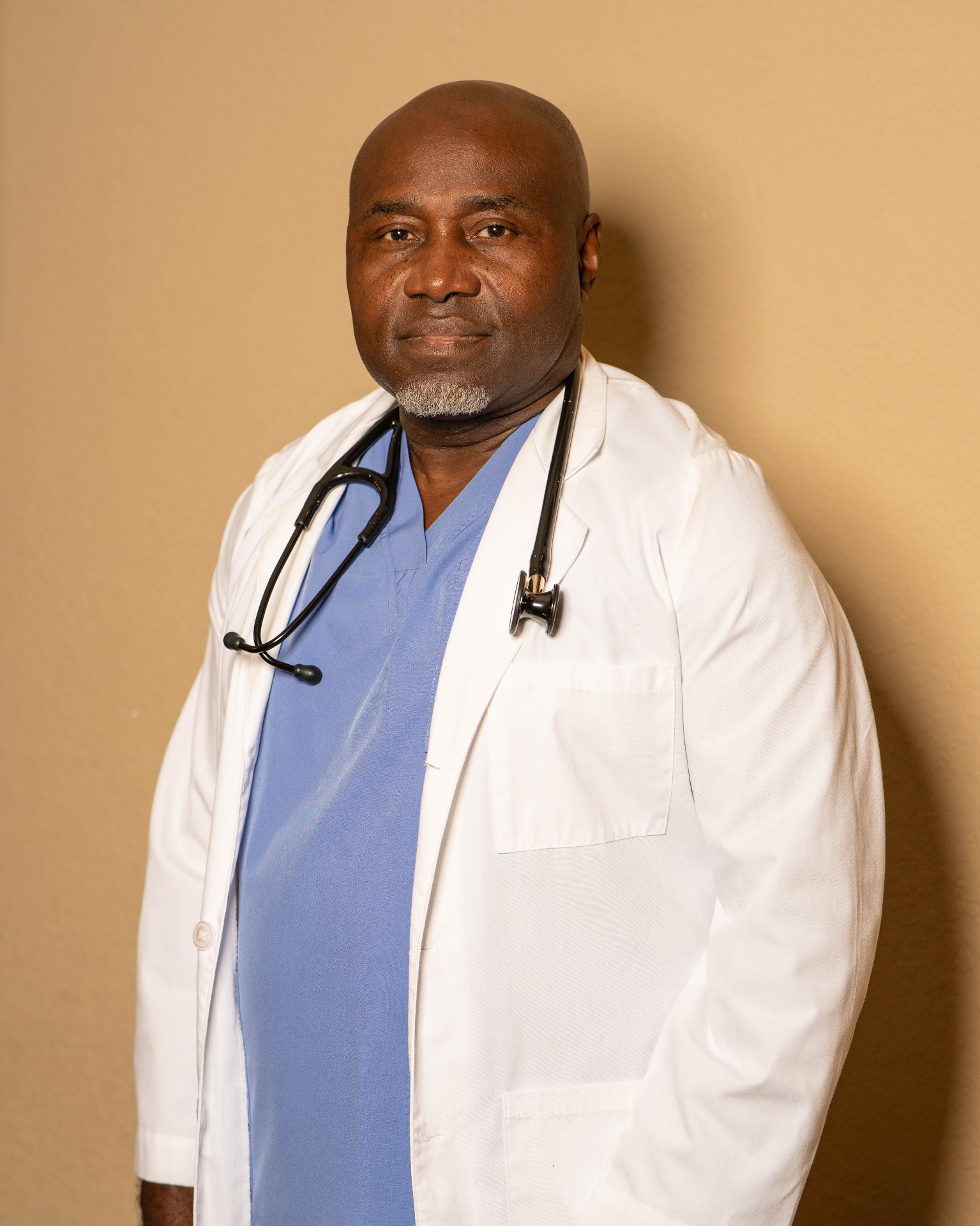 A professional home health care provider in scrubs with a stethoscope